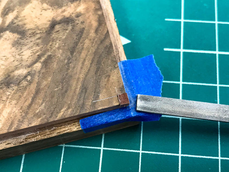 small piece of iron wood added to each corner of the top.