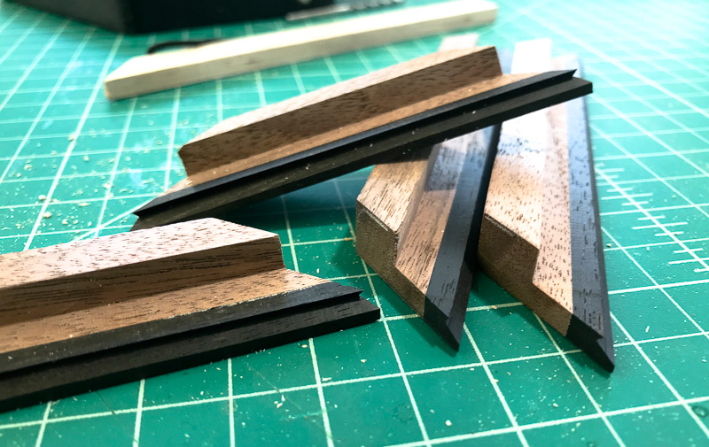 small piece of iron wood added to each corner of the top.