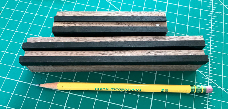 small piece of iron wood added to each corner of the top.