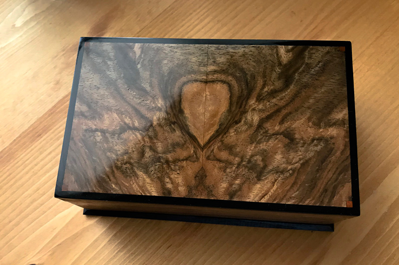 small piece of iron wood added to each corner of the top.